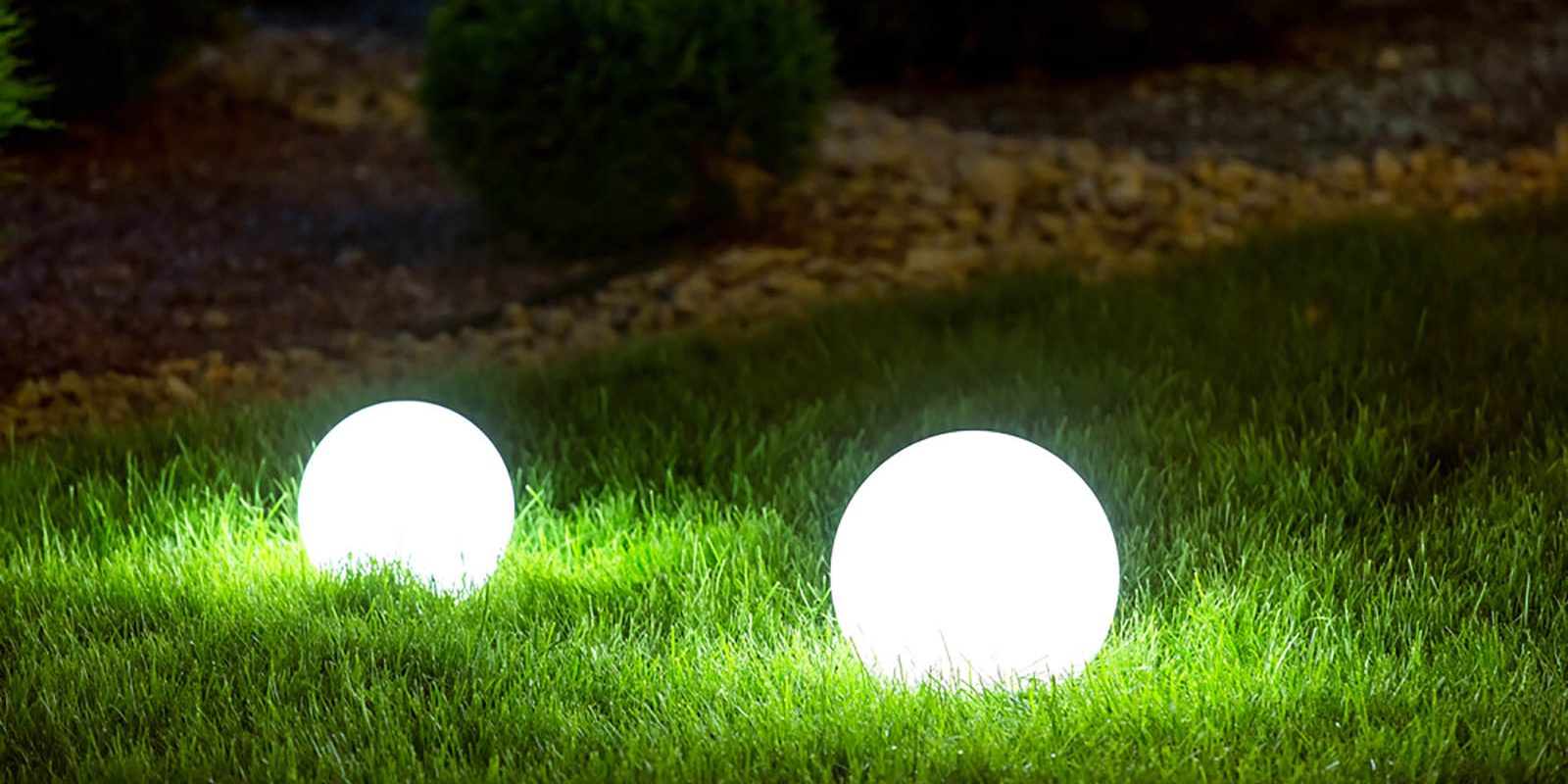 Two outdoors lighting fixtures at night